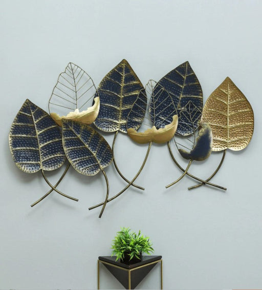 Add charm to your home with this stunning all metal leaf wall decor with its multicolor and additional gold highlights. The one piece wall decor features eight large leaves. Its trendy design makes it an eye-catching addition to any contemporary inspired decor. It is perfect for any entryway, living room, or bedroom to add personality to empty walls.