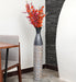 Crafted of metal, this stunning vase strikes an updated amphora silhouette with a 32" H x 8" W cylindrical body and a flared mouth. Perfect for long-stemmed florals, decorative twigs, or unfilled as a sculptural accent, Its ambiguous qualities make it a magnetic piece that guests won't be able to keep their eyes off of. This vase can be simply wiped with a dry cloth for effortless upkeep.