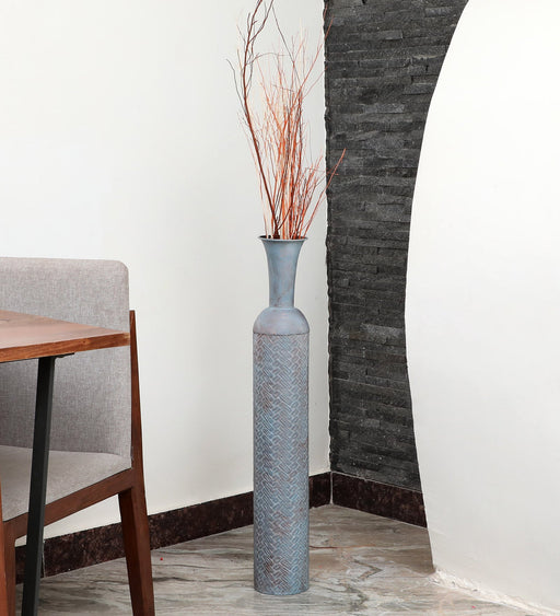 Crafted of metal, this stunning vase strikes an updated amphora silhouette with a 32" H x 8" W cylindrical body and a flared mouth. Perfect for long-stemmed florals, decorative twigs, or unfilled as a sculptural accent, Its ambiguous qualities make it a magnetic piece that guests won't be able to keep their eyes off of. This vase can be simply wiped with a dry cloth for effortless upkeep.