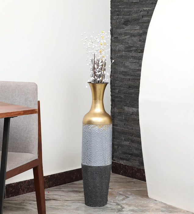 Crafted of metal, this stunning vase strikes an updated amphora silhouette with a 32" H x 8" W cylindrical body and a flared mouth. Perfect for long-stemmed florals, decorative twigs, or unfilled as a sculptural accent, Its ambiguous qualities make it a magnetic piece that guests won't be able to keep their eyes off of. This vase can be simply wiped with a dry cloth for effortless upkeep.