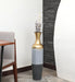 Crafted of metal, this stunning vase strikes an updated amphora silhouette with a 32" H x 8" W cylindrical body and a flared mouth. Perfect for long-stemmed florals, decorative twigs, or unfilled as a sculptural accent, Its ambiguous qualities make it a magnetic piece that guests won't be able to keep their eyes off of. This vase can be simply wiped with a dry cloth for effortless upkeep.