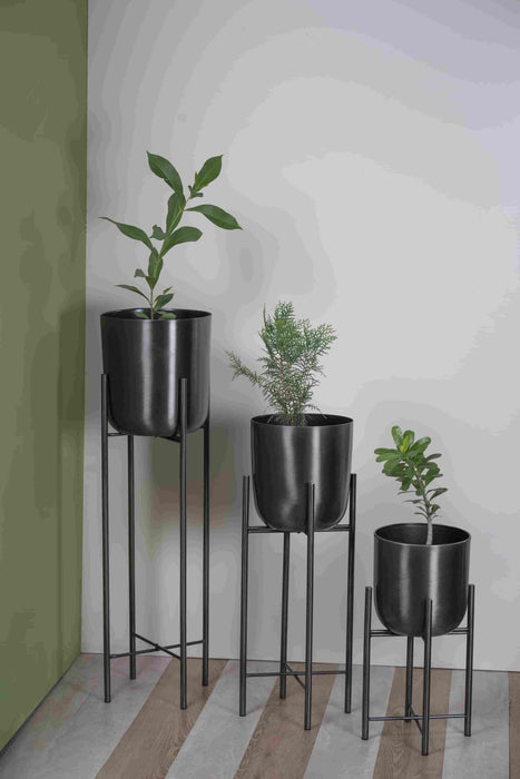 Bring a taste of the green outdoors into the comfort of your own home with just the addition of some fresh plants. Use this modern inspired pot planter to grow your favorite flower, cactus, herb and more. It features a geometric stand, that allows this piece to be placed on the ground next to a desk, fireplace, or seating arrangement. The planter itself is crafted from galvanized metal.