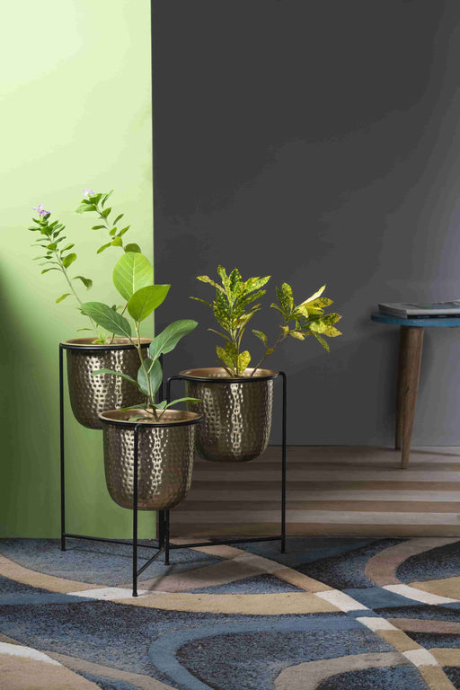 Bring a taste of the green outdoors into the comfort of your own home with just the addition of some fresh plants. Use this modern inspired pot planter to grow your favorite flower, cactus, herb and more. It features a geometric stand, that allows this piece to be placed on the ground next to a desk, fireplace, or seating arrangement. The planter itself is crafted from galvanized metal.