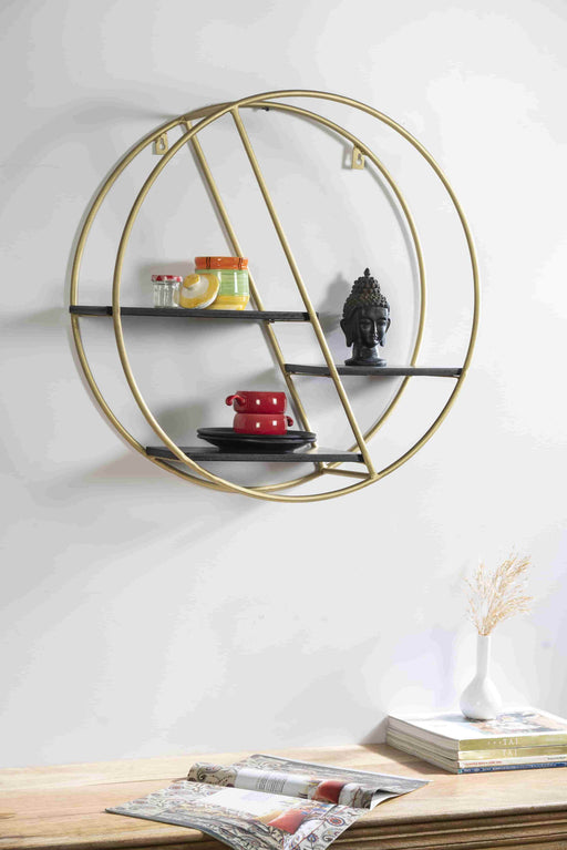 Turn any empty wall into a contemporary display with this wall shelf. Crafted of metal in a gold finish, Inside, three shelves are laid out asymmetrically – each a different size and shape – for you to display books, framed photos, small sculptures, and collected curios. Measuring 23" H x 23" W x 7" D overall, this shelf includes keyhole hangers for effortless installation.