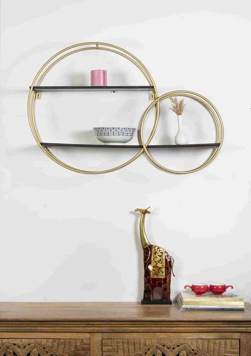 Turn any empty wall into a contemporary display with this wall shelf. Crafted of metal in a gold finish, Inside, three shelves are laid out asymmetrically – each a different size and shape – for you to display books, framed photos, small sculptures, and collected curios. Measuring 23" H x 35" W x 7" D overall, this shelf includes keyhole hangers for effortless installation.