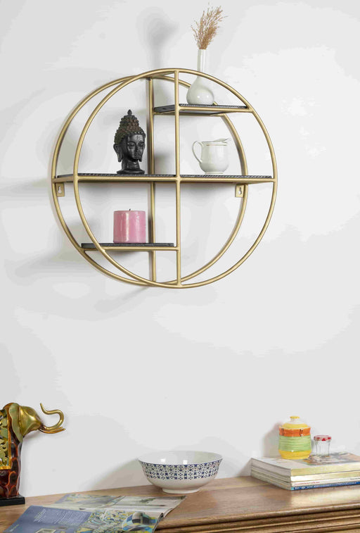 Turn any empty wall into a contemporary display with this wall shelf. Crafted of metal in a gold finish, Inside, four shelves are laid out asymmetrically – each a different size and shape – for you to display books, framed photos, small sculptures, and collected curios. Measuring 20" H x 20" W x 7" D overall, this shelf includes keyhole hangers for effortless installation.